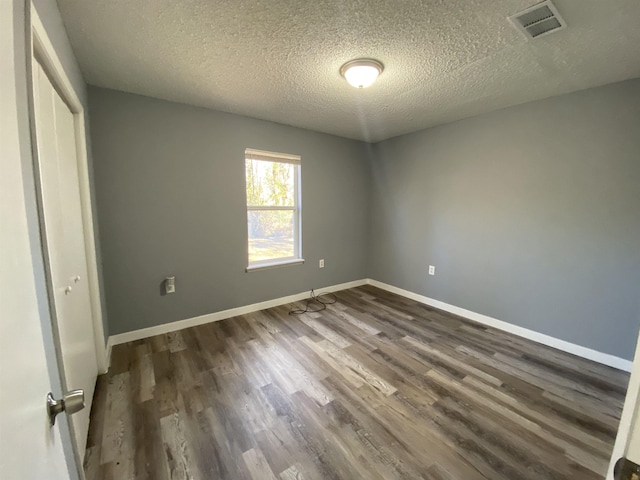 4350 Fortner Cir, Perry, FL 32347 - unfurnished bedroom with wood finished floors, a textured ceiling, and a closet