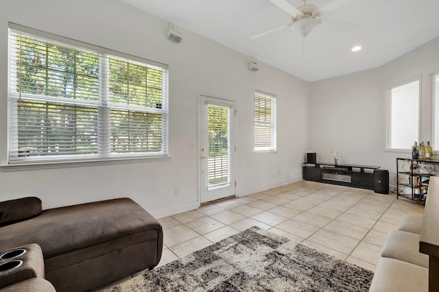 tiled living room featuring a wealth of natural light and ceiling fan