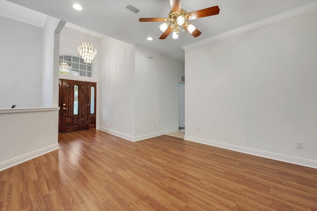 entryway featuring light wood-type flooring, ornamental molding, and ceiling fan with notable chandelier