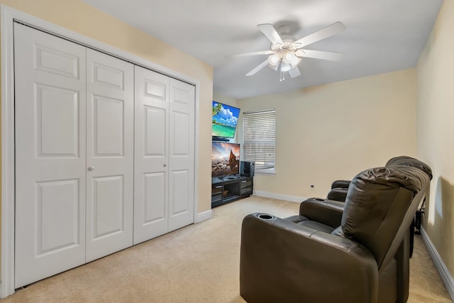 living area featuring ceiling fan and light carpet