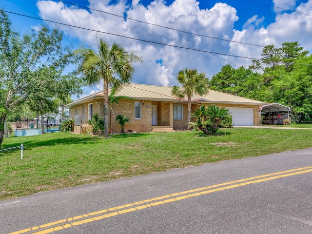 ranch-style home with a front lawn, a garage, and a carport