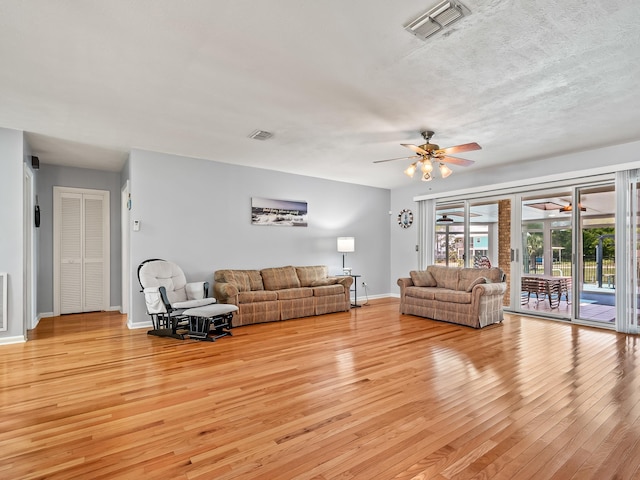 living room with ceiling fan and light hardwood / wood-style floors