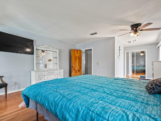 bedroom with a closet, ceiling fan, and hardwood / wood-style flooring