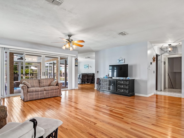 living room featuring hardwood / wood-style floors and ceiling fan