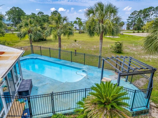 view of pool featuring a patio area and a yard