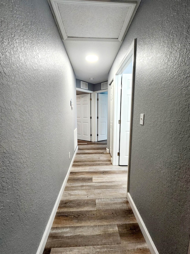 hall featuring wood-type flooring and ornamental molding