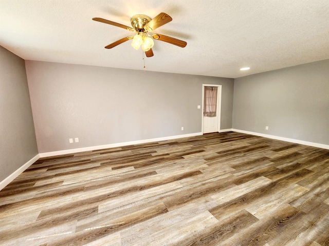 unfurnished room featuring a textured ceiling, hardwood / wood-style flooring, and ceiling fan