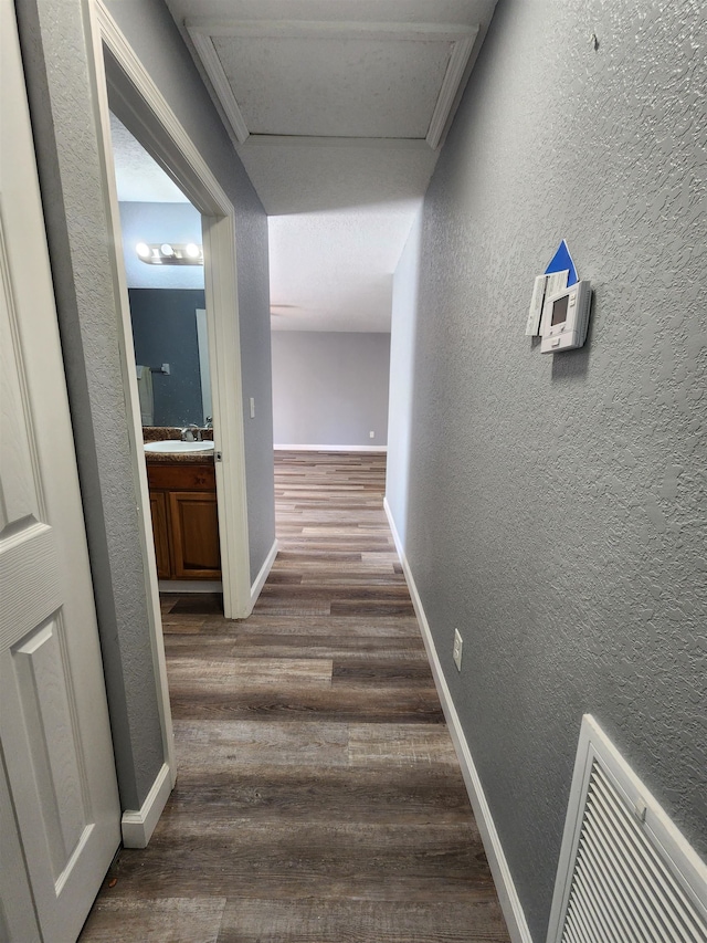 hall featuring dark hardwood / wood-style floors and sink