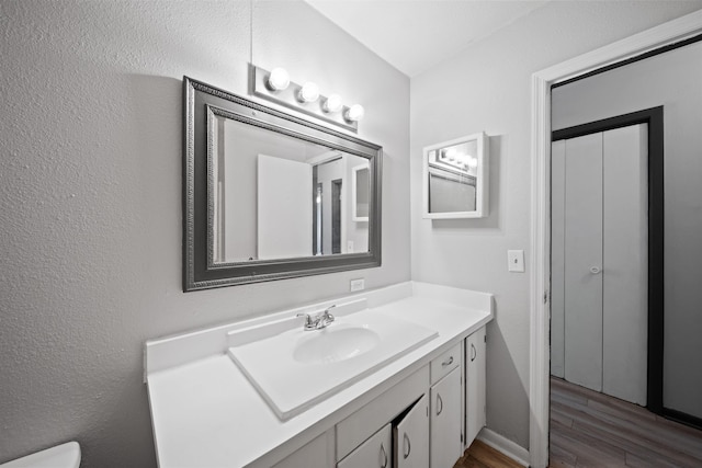 2401 Hideaway Ct, Tallahassee, FL 32303 - bathroom with baseboards, wood finished floors, and vanity