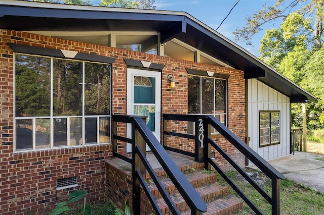 2401 Hideaway Ct, Tallahassee, FL 32303 - view of exterior entry with board and batten siding and brick siding