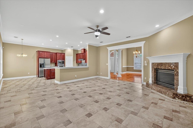 5127 Wild Rose Way, Tallahassee, FL 32312 - unfurnished living room with a chandelier, recessed lighting, a ceiling fan, a high end fireplace, and crown molding