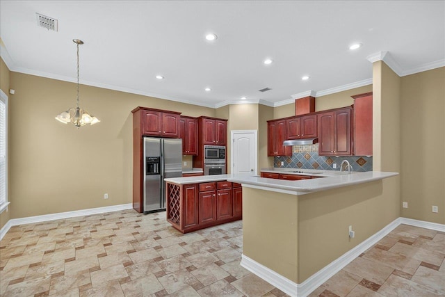 5127 Wild Rose Way, Tallahassee, FL 32312 - kitchen with stainless steel appliances, dark brown cabinets, a chandelier, light countertops, and decorative backsplash