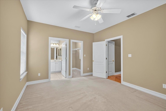 5127 Wild Rose Way, Tallahassee, FL 32312 - unfurnished bedroom featuring light colored carpet, a spacious closet, a closet, and connected bathroom