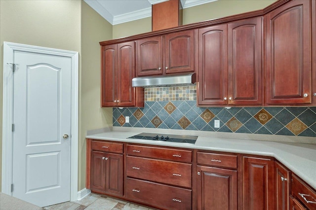 5127 Wild Rose Way, Tallahassee, FL 32312 - kitchen with black electric stovetop, under cabinet range hood, ornamental molding, light countertops, and tasteful backsplash