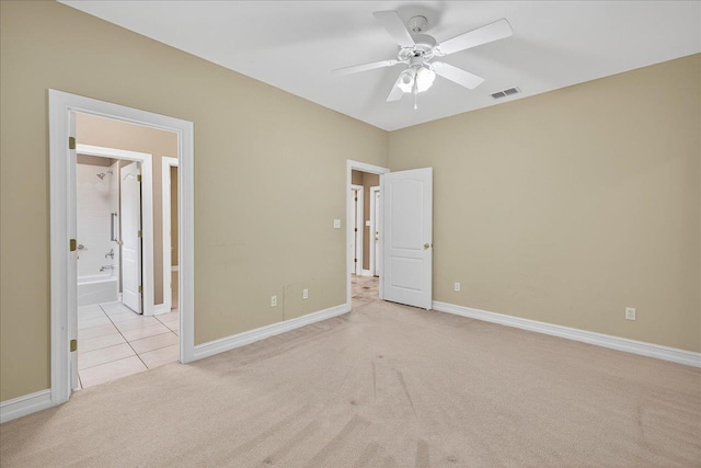 5127 Wild Rose Way, Tallahassee, FL 32312 - unfurnished bedroom featuring light carpet, ensuite bathroom, light tile patterned floors, and ceiling fan