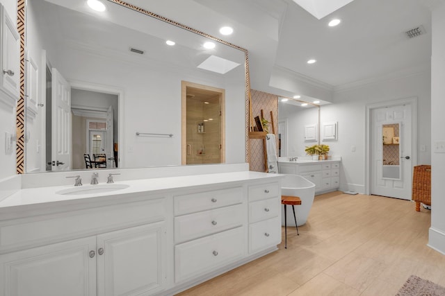 8555 Congressional Dr, Tallahassee, FL 32312 - full bathroom with ornamental molding, a shower stall, vanity, a soaking tub, and recessed lighting