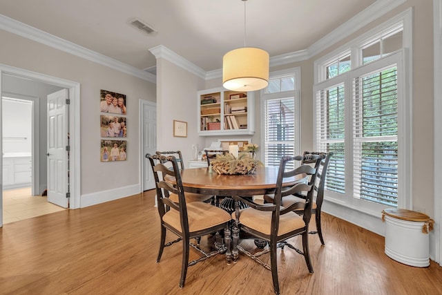 8555 Congressional Dr, Tallahassee, FL 32312 - dining area featuring crown molding, light wood-style floors, and baseboards