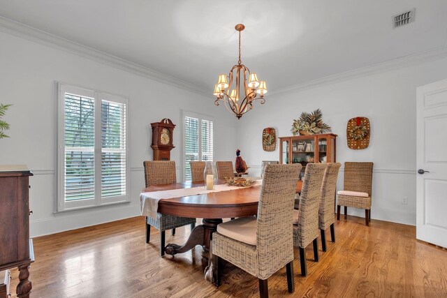 8555 Congressional Dr, Tallahassee, FL 32312 - dining room with crown molding, a chandelier, and light wood-style floors