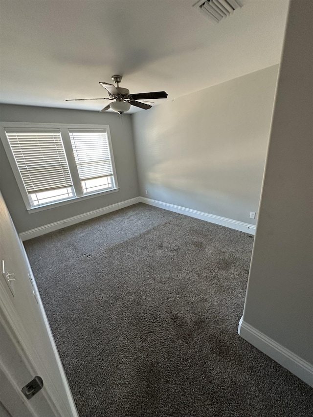 carpeted spare room featuring ceiling fan