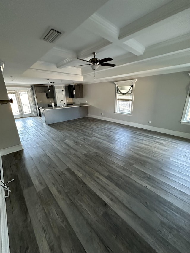 unfurnished living room featuring beam ceiling, ceiling fan, dark wood-type flooring, and coffered ceiling