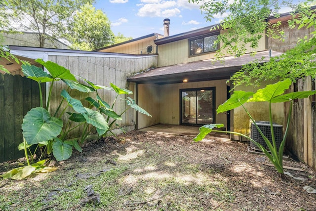 rear view of house featuring central air condition unit and a patio