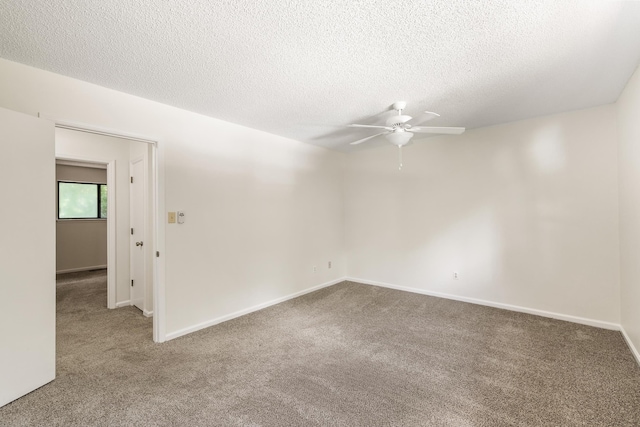 spare room featuring carpet flooring, ceiling fan, and a textured ceiling