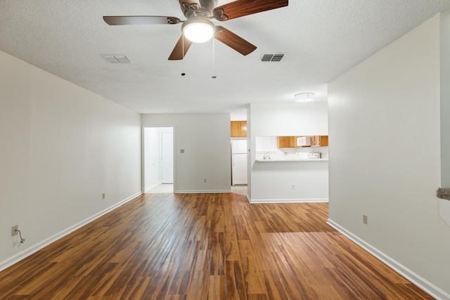 unfurnished living room with hardwood / wood-style floors, a textured ceiling, and ceiling fan