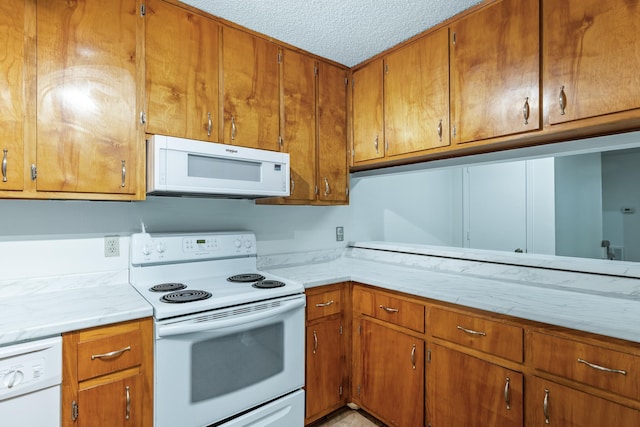 kitchen featuring white appliances and a textured ceiling