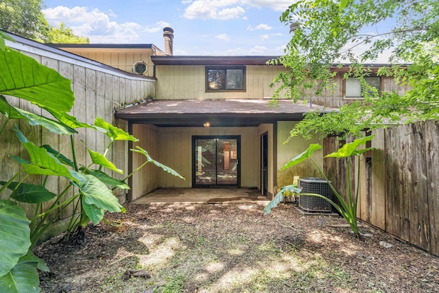 rear view of house with a patio and central AC