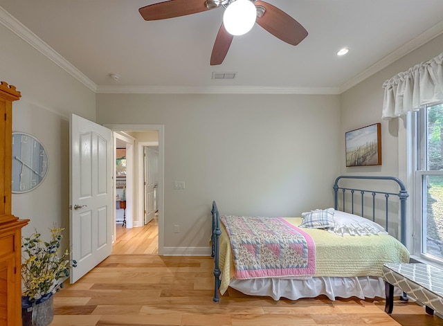 bedroom with baseboards, ornamental molding, light wood-style flooring, visible vents, and ceiling fan