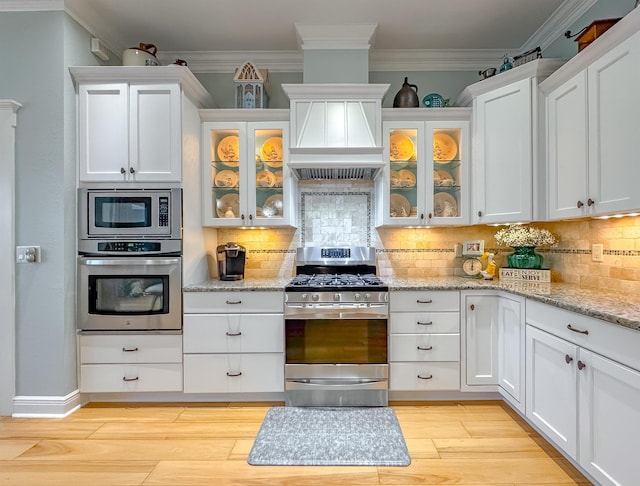 kitchen featuring ornamental molding, white cabinets, and stainless steel appliances