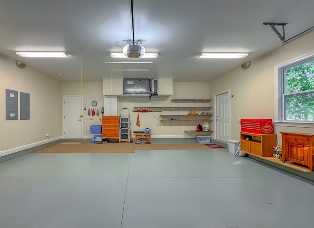 garage with baseboards, a garage door opener, and electric panel