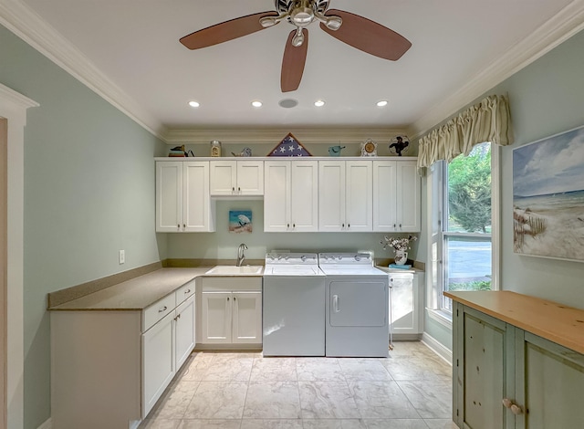 laundry area featuring washer and dryer, plenty of natural light, a sink, a ceiling fan, and cabinet space