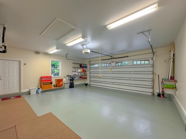garage with a garage door opener and baseboards