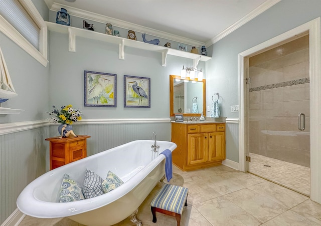 bathroom with vanity, a stall shower, crown molding, wainscoting, and a freestanding bath