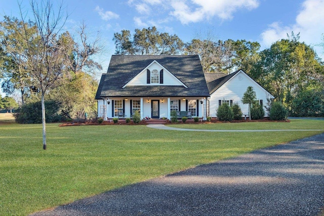 cape cod home with a front lawn and a porch