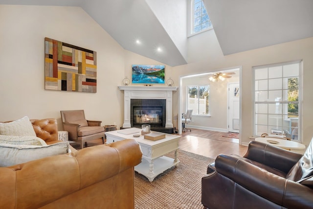 living room featuring high vaulted ceiling and light hardwood / wood-style floors