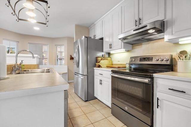 kitchen with sink, white cabinets, light tile patterned floors, and stainless steel appliances