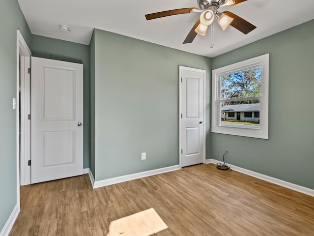 unfurnished bedroom with ceiling fan and light hardwood / wood-style flooring