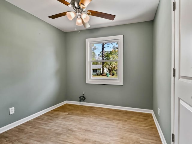 empty room with ceiling fan and light wood-type flooring