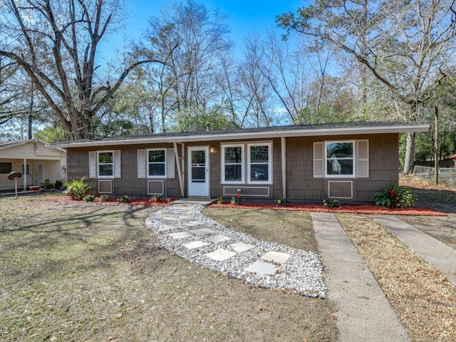 ranch-style home with a front yard