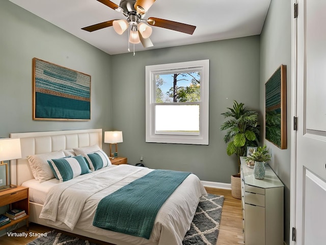 bedroom with ceiling fan and light wood-type flooring