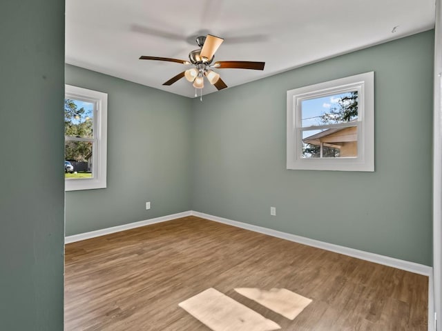 unfurnished room with ceiling fan and light wood-type flooring