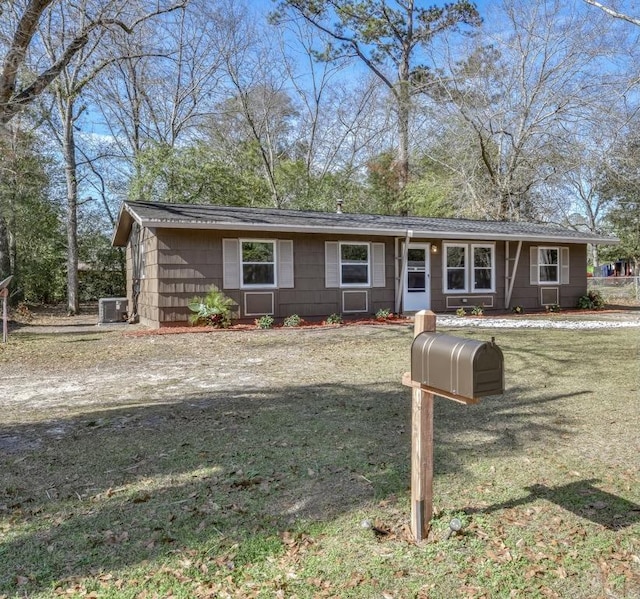 ranch-style house with central AC and a front lawn