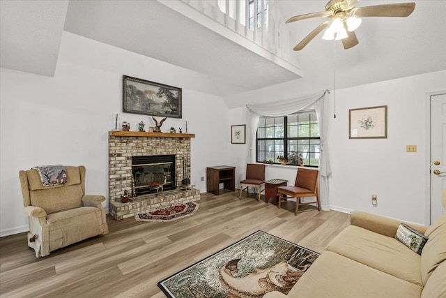 2758 Deborah Dr, Tallahassee, FL 32310 - living area with light wood-style floors, a ceiling fan, a fireplace, and baseboards