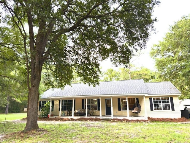 415 Hunters Trce, Crawfordville, FL 32327 - single story home with covered porch, a front yard, and roof with shingles