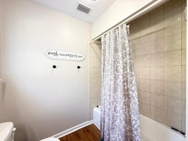 415 Hunters Trce, Crawfordville, FL 32327 - bathroom featuring shower / bath combo and wood finished floors