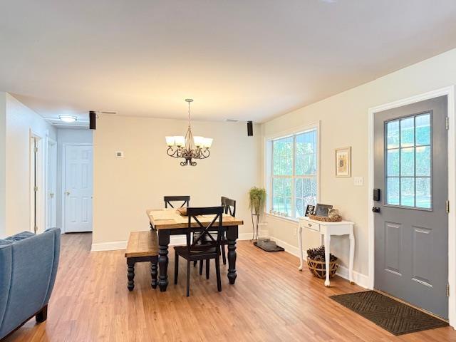 415 Hunters Trce, Crawfordville, FL 32327 - dining room featuring plenty of natural light, light wood finished floors, and a chandelier