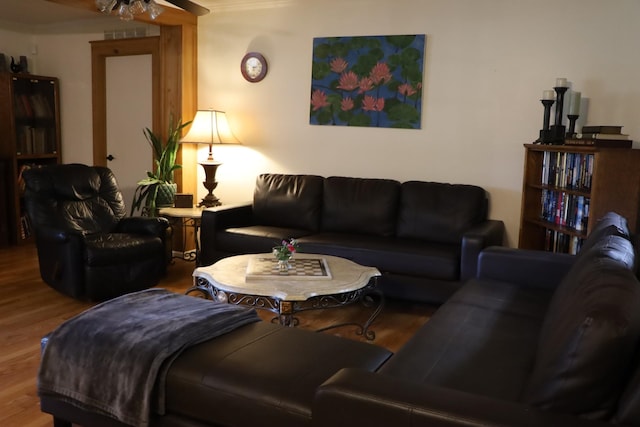 living room featuring wood-type flooring and ceiling fan