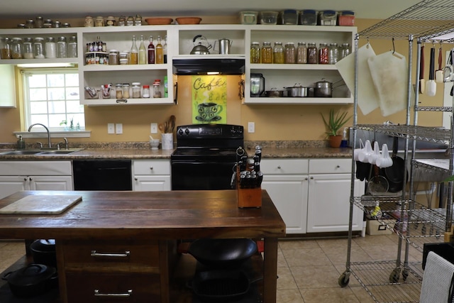 kitchen with white cabinetry, sink, black appliances, light tile patterned floors, and wood counters